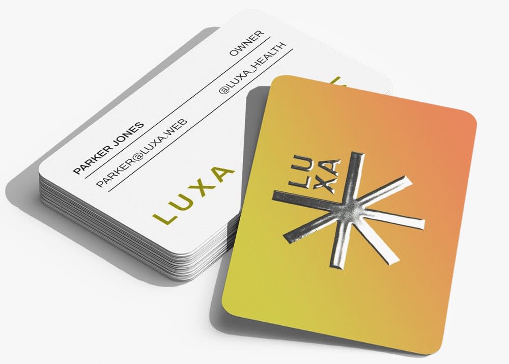 A business card with rounded corners and metallic foil stamping accents