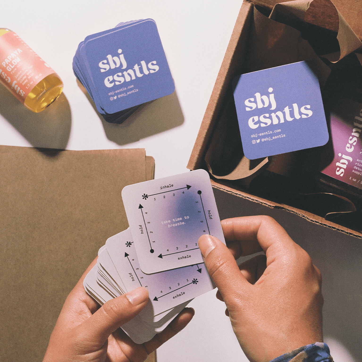 Purple square business cards used as packaging inserts for a retail business