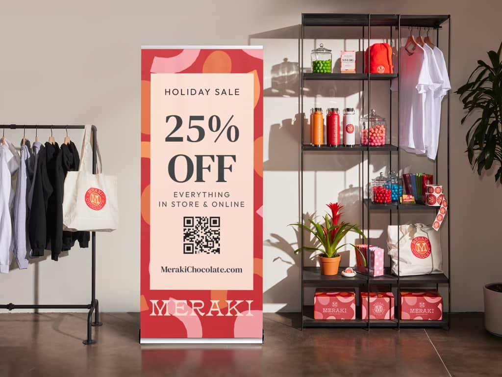 Retractable banner with a QR code promoting a 25% off holiday sale