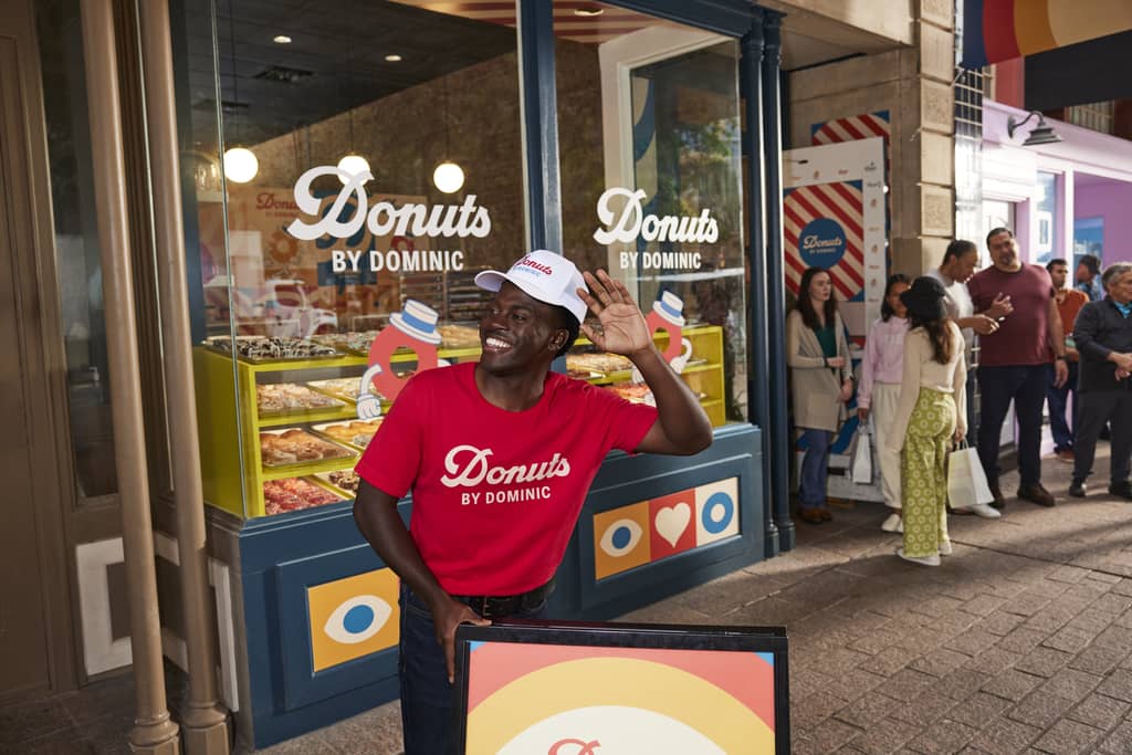 Donut business logo on storefront window decals, signage and staff uniforms