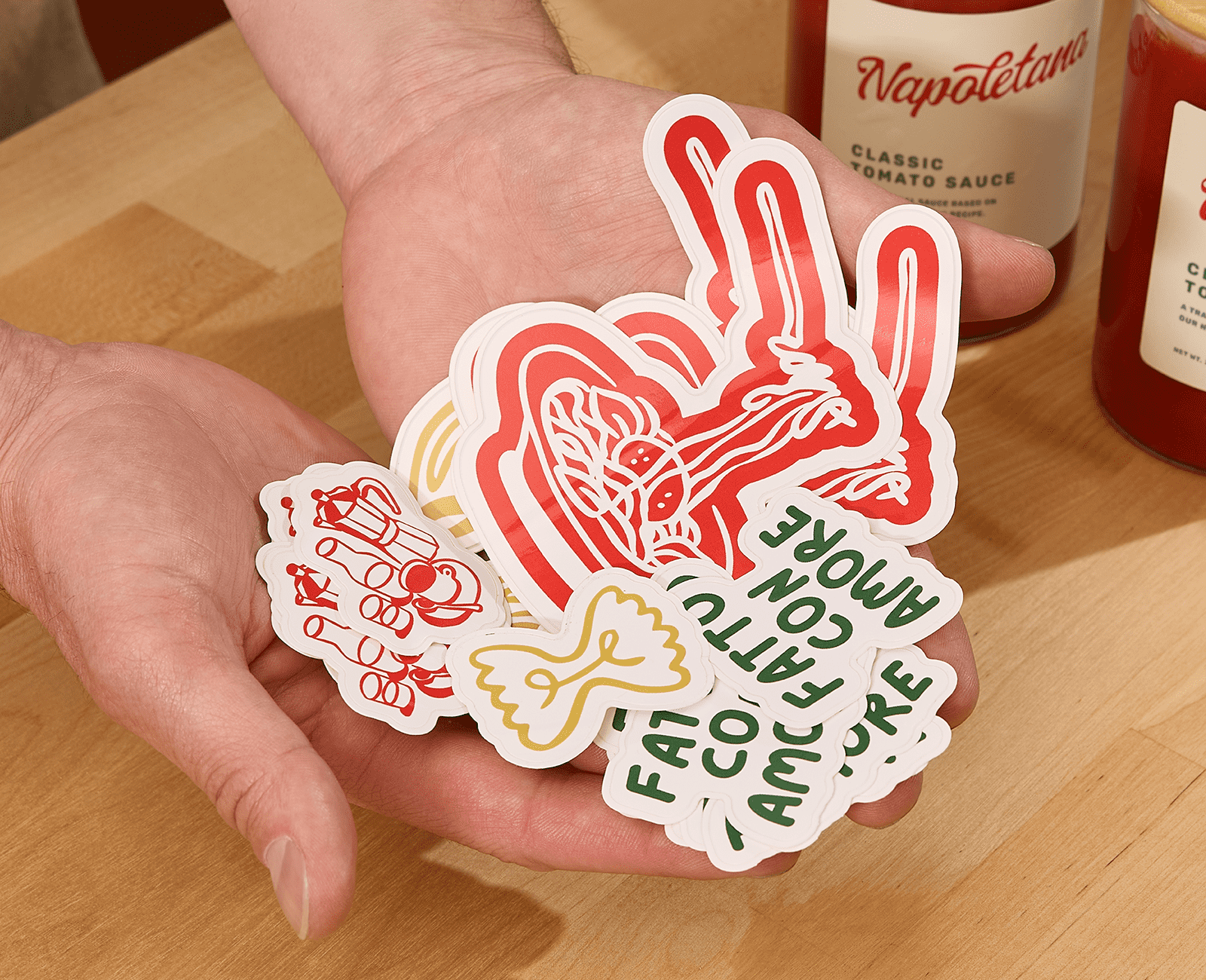 A selection of multi-colored branded die-cut stickers used for promotional packaging campaigns