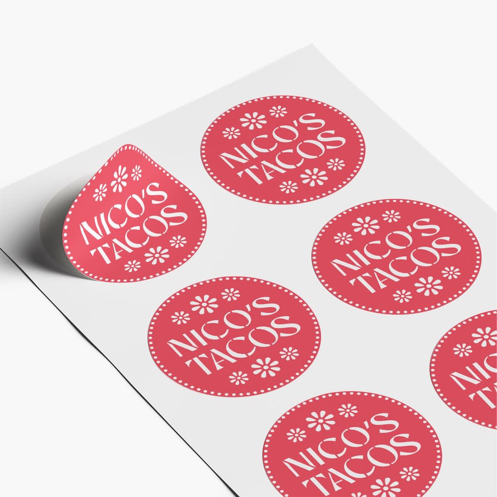 Sheet of round red stickers with white brand name, &ldquo;Nico&rsquo;s Tacos&rdquo; and simple floral accents