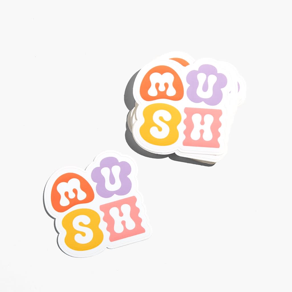 Stack of colorful die-cut stickers spelling &ldquo;MUSH&rdquo; in bold, playful letterforms, showing a simple, high-contrast design that reads clearly at small scale