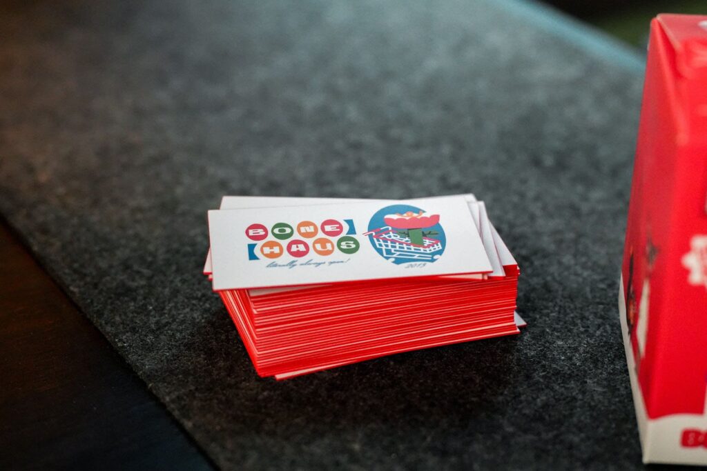Stack of minimalist Bonehaus business cards with simple icon-based design and minimal text, illustrating reduced information and a focus on visual elements