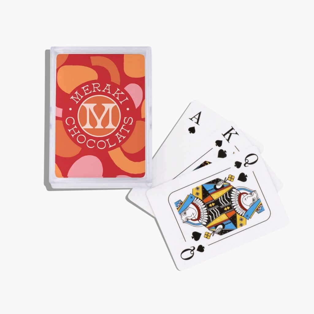 A deck of personalized playing cards with the brand logo and pattern.