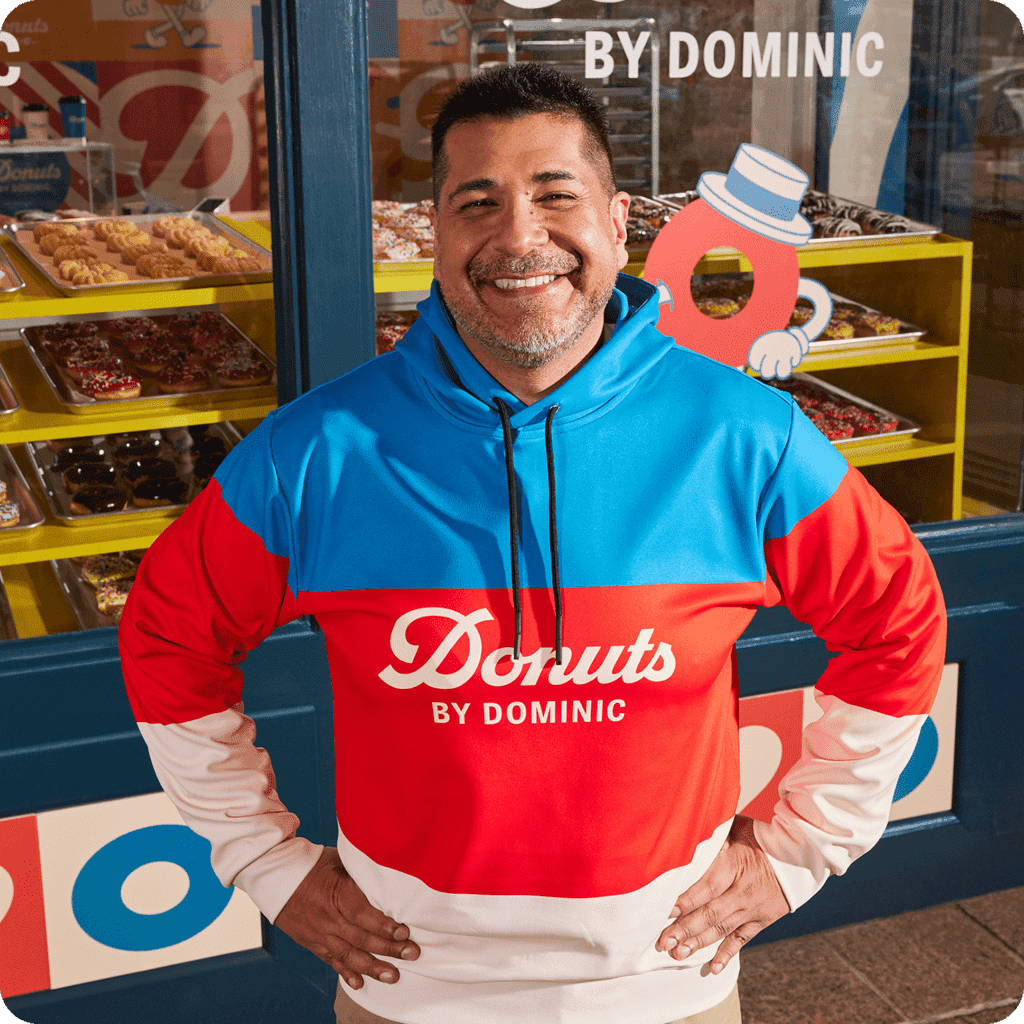 An employee wearing a branded hoodie in brand colors with a brand logo on the chest