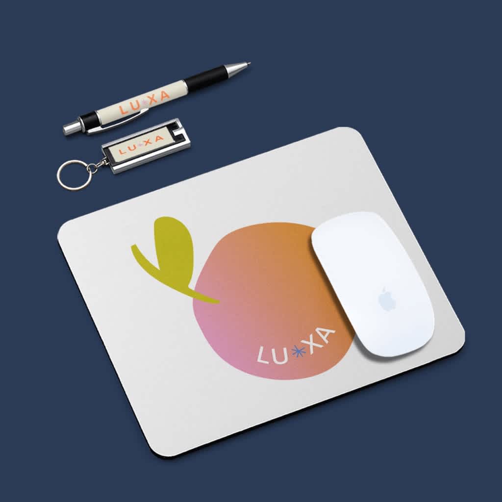 White mouse pad with a bold colorful logo and a branded pen and keyring.