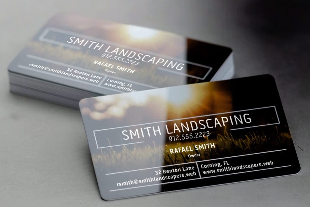 Waterproof business cards for a landscaping company with a full-color outdoor photo design made out of white plastic.