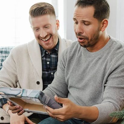 two men exchanging a canvas photo print as a gift at christmas
