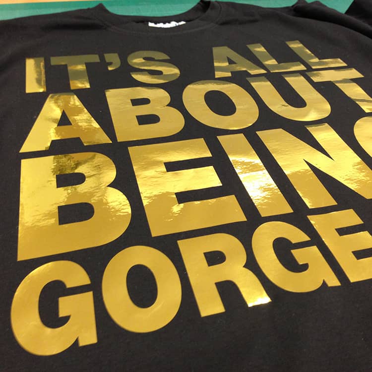 Gold vinyl graphics transferred onto a black T-shirt
