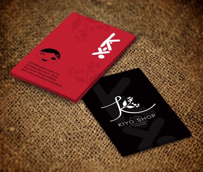 Red and black business cards with a large letterform logo