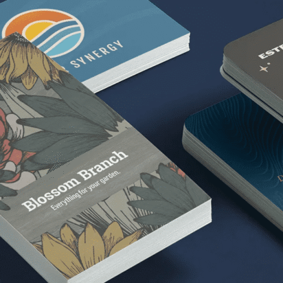 Stack of business cards in various styles featuring serif, sans-serif and script fonts with diverse layouts and textures