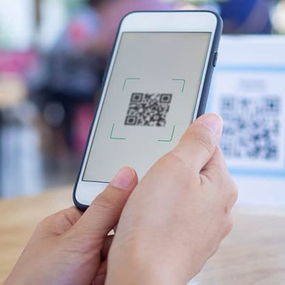 Woman scans an event QR code with her smartphone