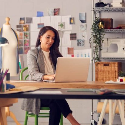 A small business owner reads Google reviews on a laptop