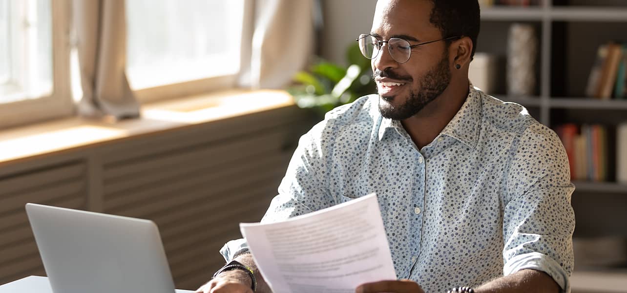 A small business owner smiles getting paperwork in order