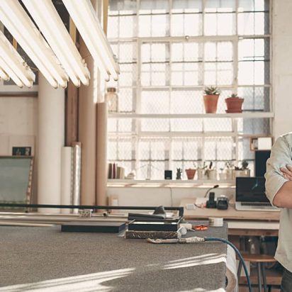 Business owner smiles in his new studio