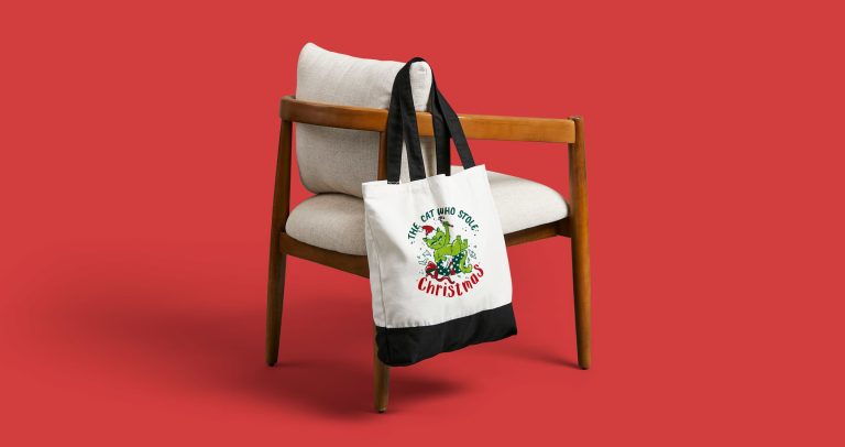 Custom holiday tote hanging off a chair