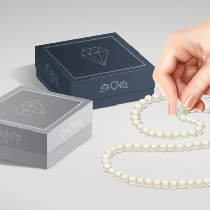 An example of jewelry packaging showing two boxes of different colors and a pearl necklace.