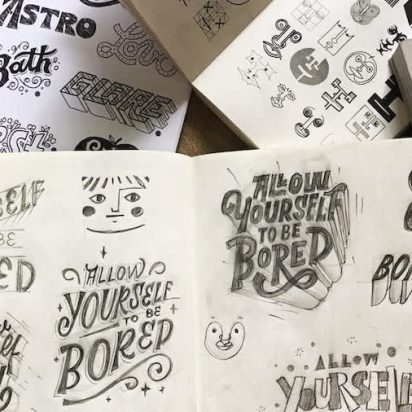 Image of notebook filled with sketches for logo design ideas