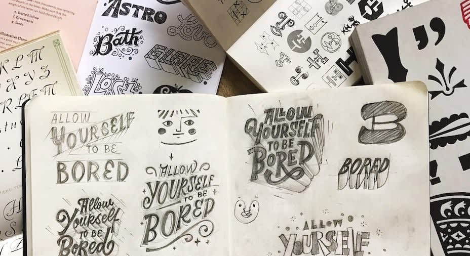 Image of notebook filled with sketches for logo design ideas