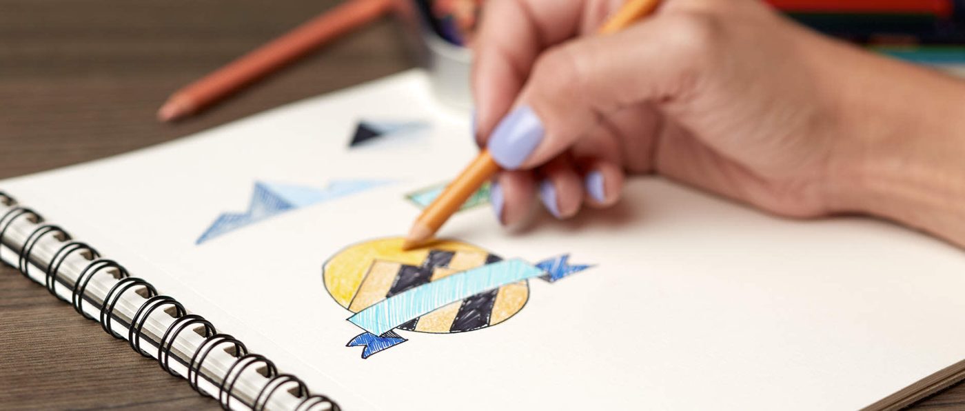 A person drawing a logo