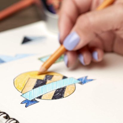 A person drawing a logo