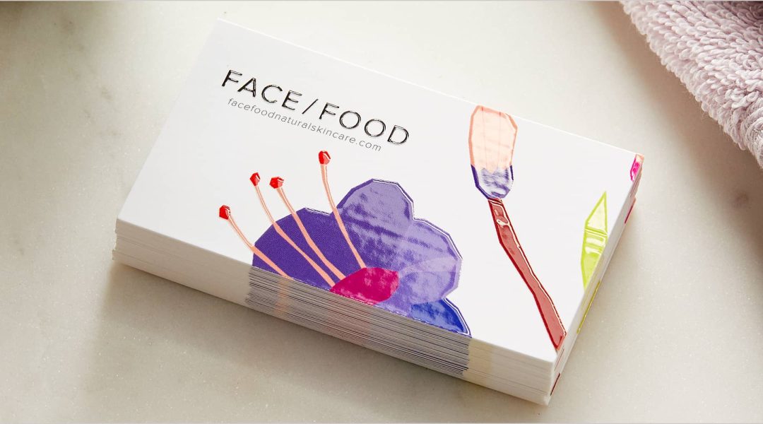 Floral embossed business card for brand called "FACE/FOOD