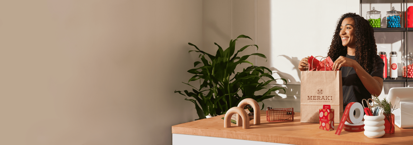 small business owner proudly displays custom print marketing materials