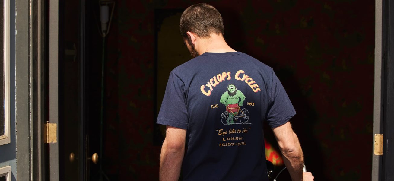 Man wearing branded bike repair shop t-shirt