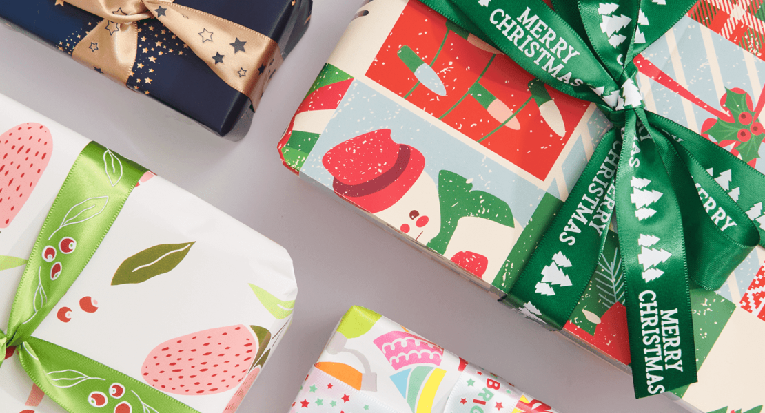 Christmas gifts wrapped in bright patterned paper and ribbon
