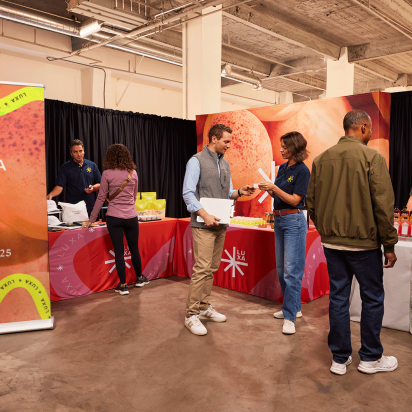 Trade Show Booth Ideas: attendees exploring colorful branded stands, promotional materials, and signage.