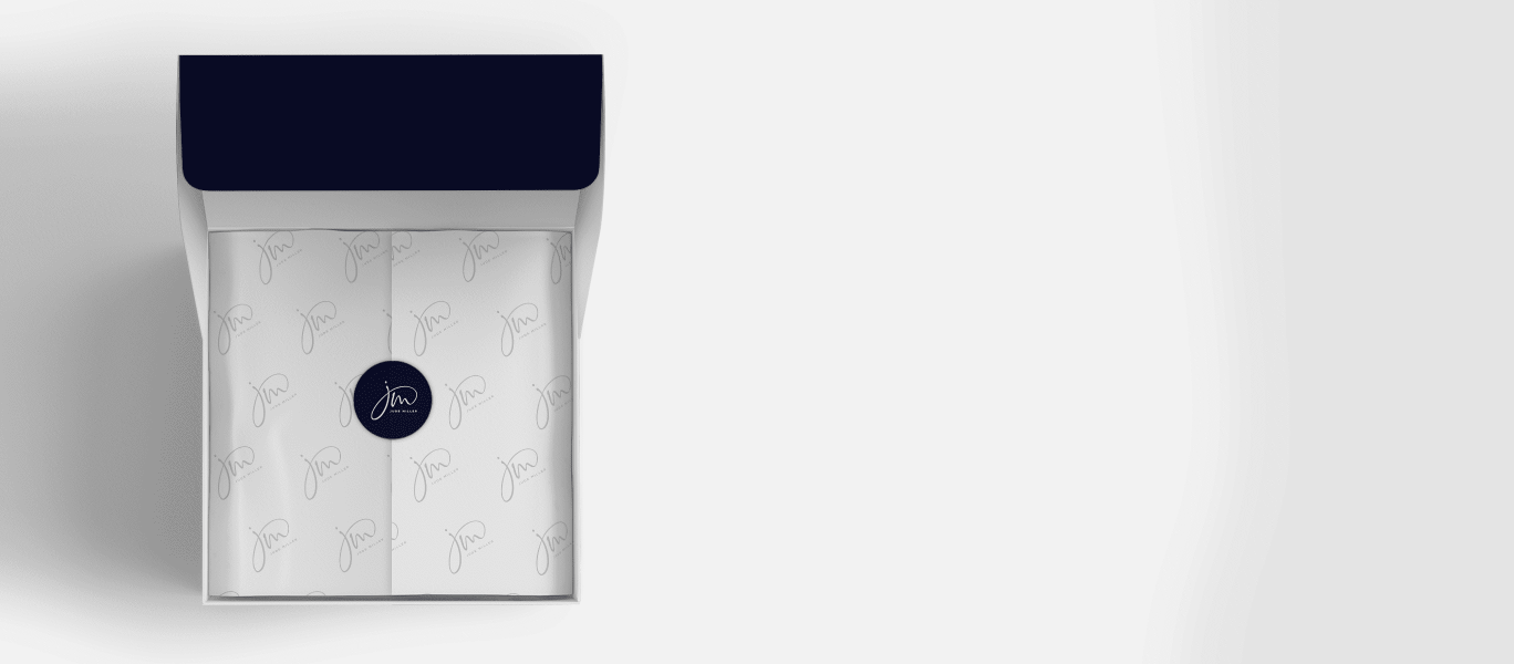 open cardboard gift box with paper neatly folded and sealed with a sticker