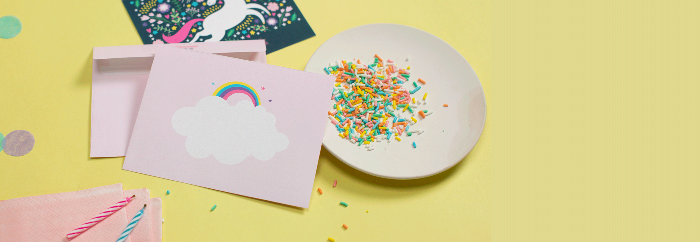 party decorations and sprinkles with a pastel-colored rainbow theme