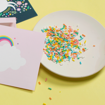 party decorations and sprinkles with a pastel-colored rainbow theme