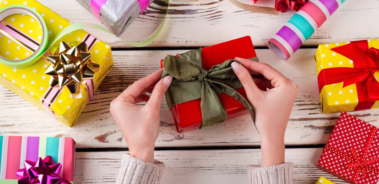 Woman wrapping a presents in beautiful colors