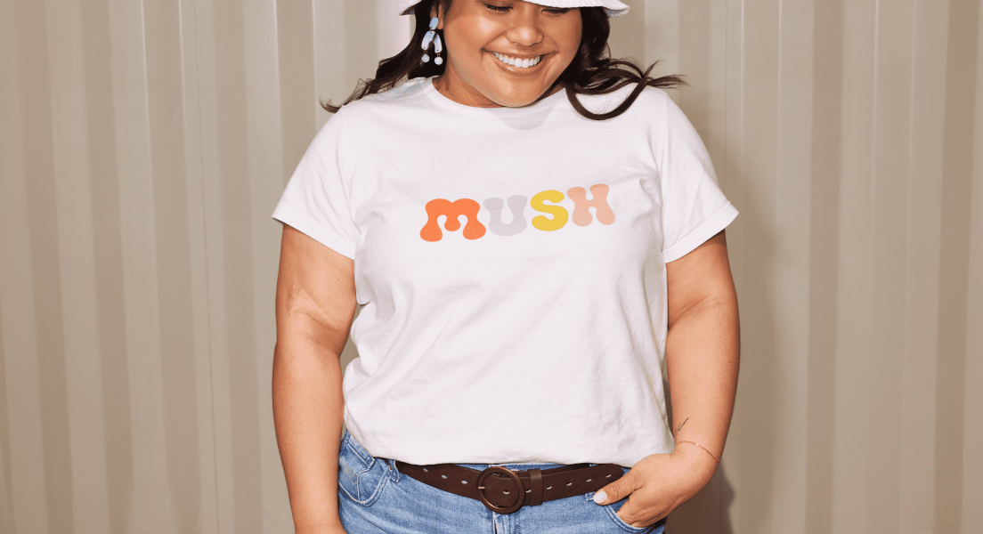 Gen Z woman wearing a branded t shirt and smiling
