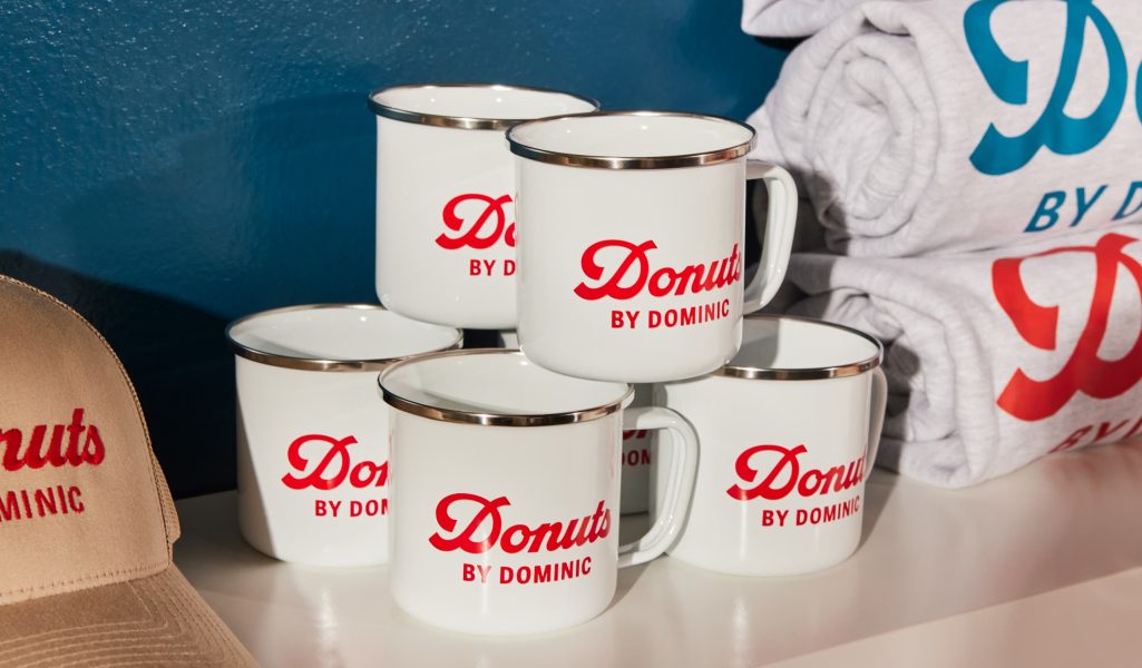 white mugs with retro red text brand name placed on top of each other