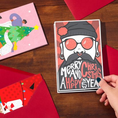 hand picks up Christmas card