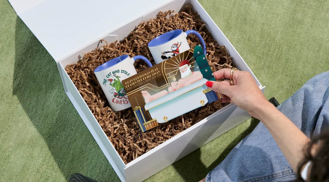 hand opening gift basket to see christmas card