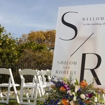 wedding logo printed on sign in outdoor ceremony
