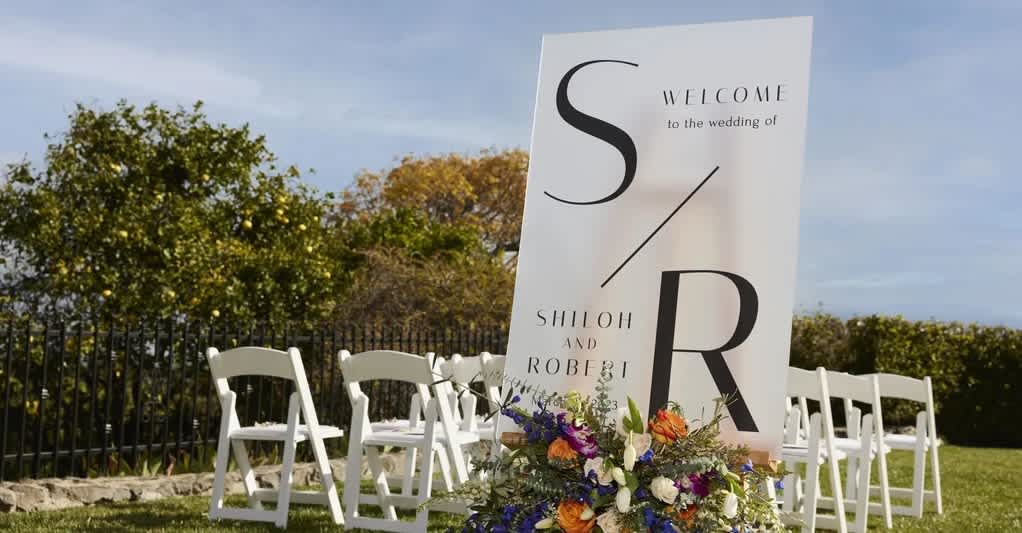 wedding logo printed on sign in outdoor ceremony