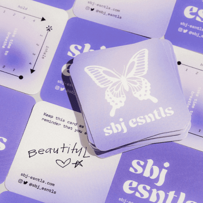 Square business cards in a checkerboard layout with AI-designed butterfly-inspired logos, geometric patterns, and handwritten-style elements.