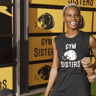 Woman in sleeveless fitness apparel with gym brand logo.
