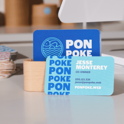 Elegant and original business card design resembling playing cards, displayed on a candle-decorated table in soft, calming tones.