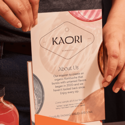 Marque image of a flyer being held beside some bottled products.