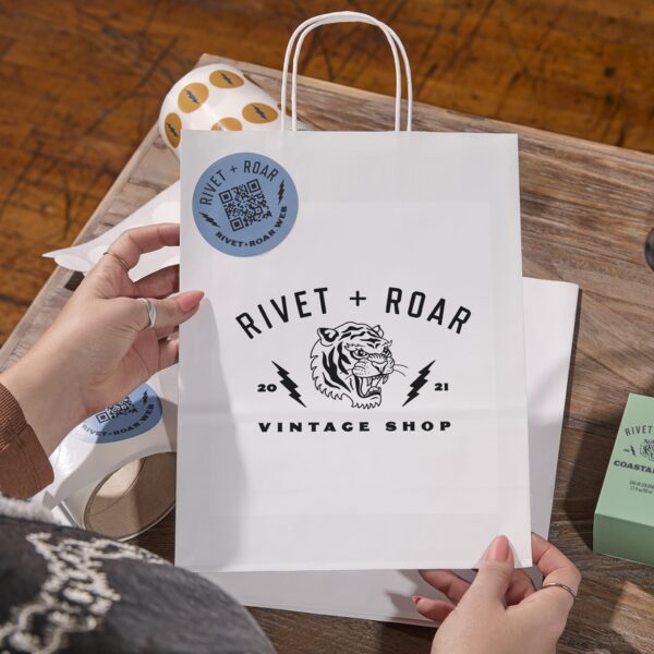 Black logo printed on white paper bag