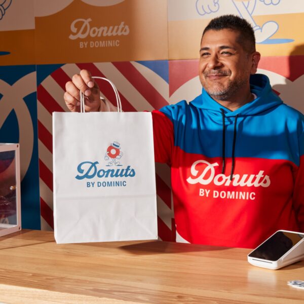 Donut brand with blue logo printed on white paper bag