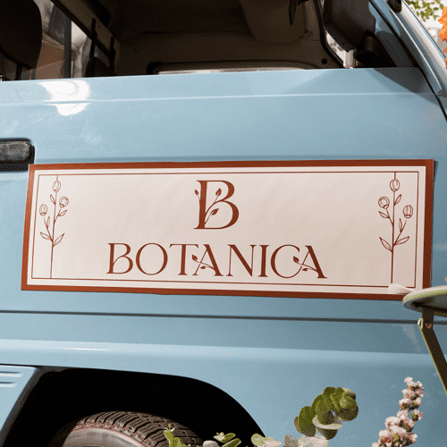 Classic logo design with flourishes printed on a car decal