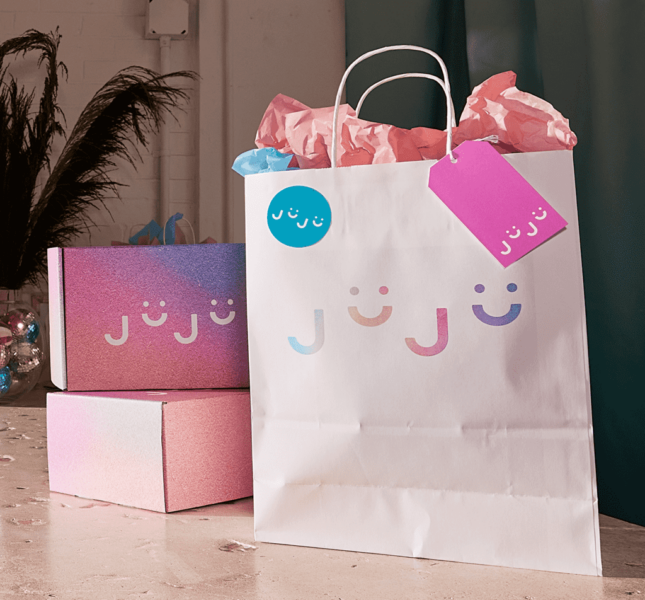 Pink logo printed on white paper bag