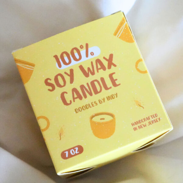 Yellow logo printed on candle packaging